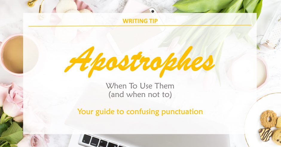 White desk with computer, flowers and tea with text overlay – Apostrophes – when (and when not) to use them